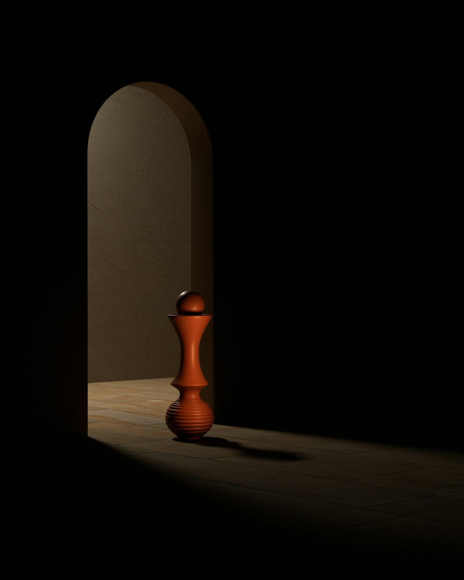 A terracotta sculptural form standing in a softly lit stone archway
